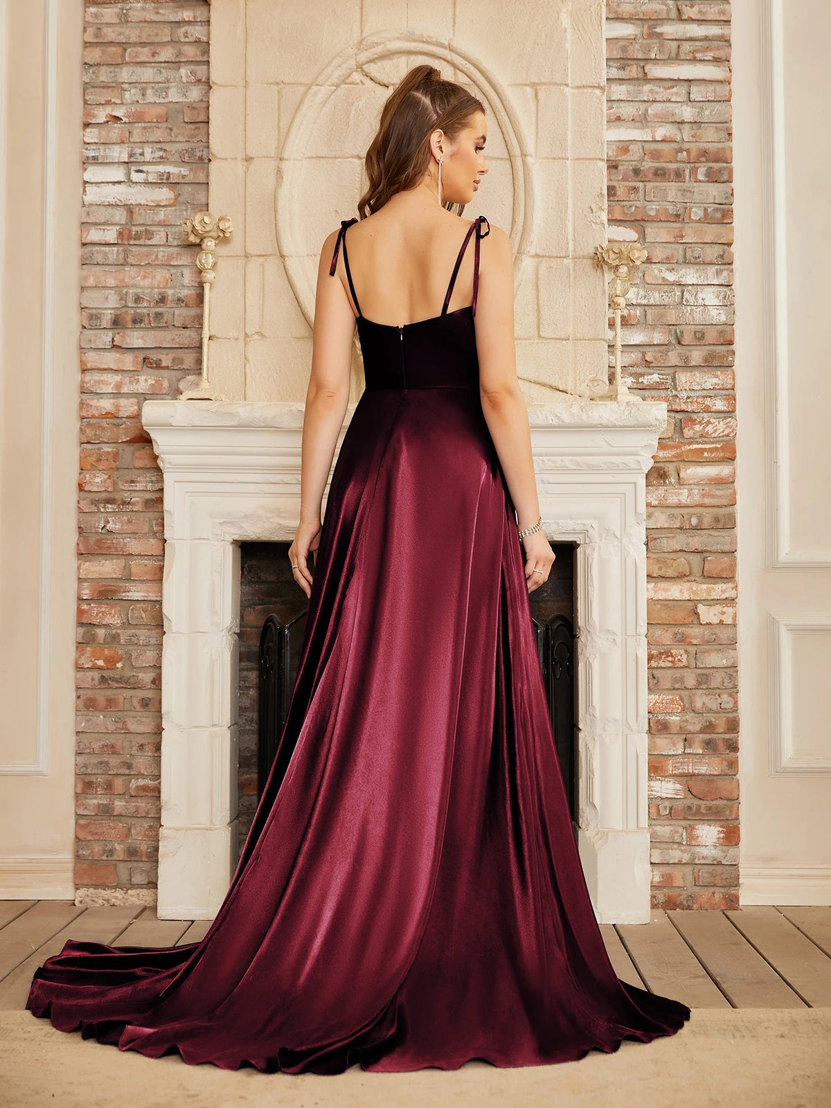 Mint green bridesmaid gown by The Clothing Company Sydney featuring a side slit, backless design, long satin fabric, and spaghetti straps.