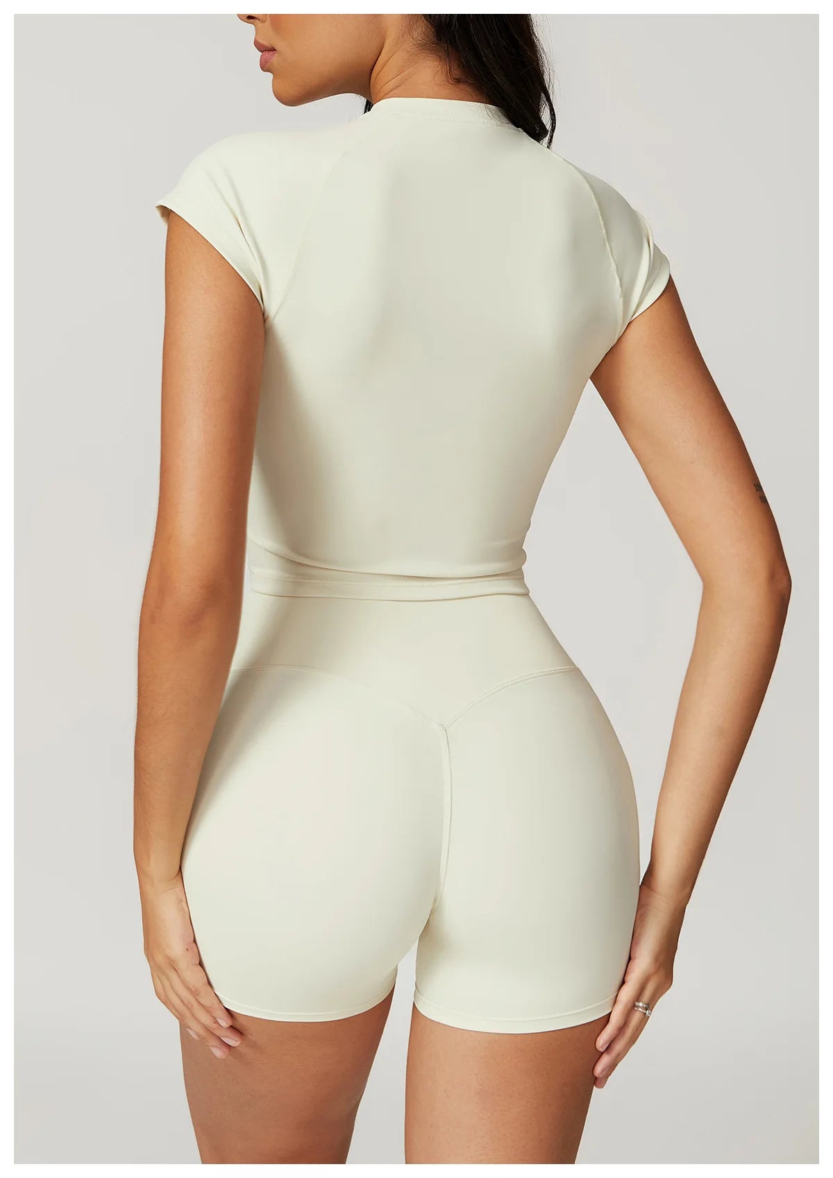 Two-piece women's fitness set by The Clothing Company Sydney, featuring a crop top, sports bra, and gym leggings with bike shorts.