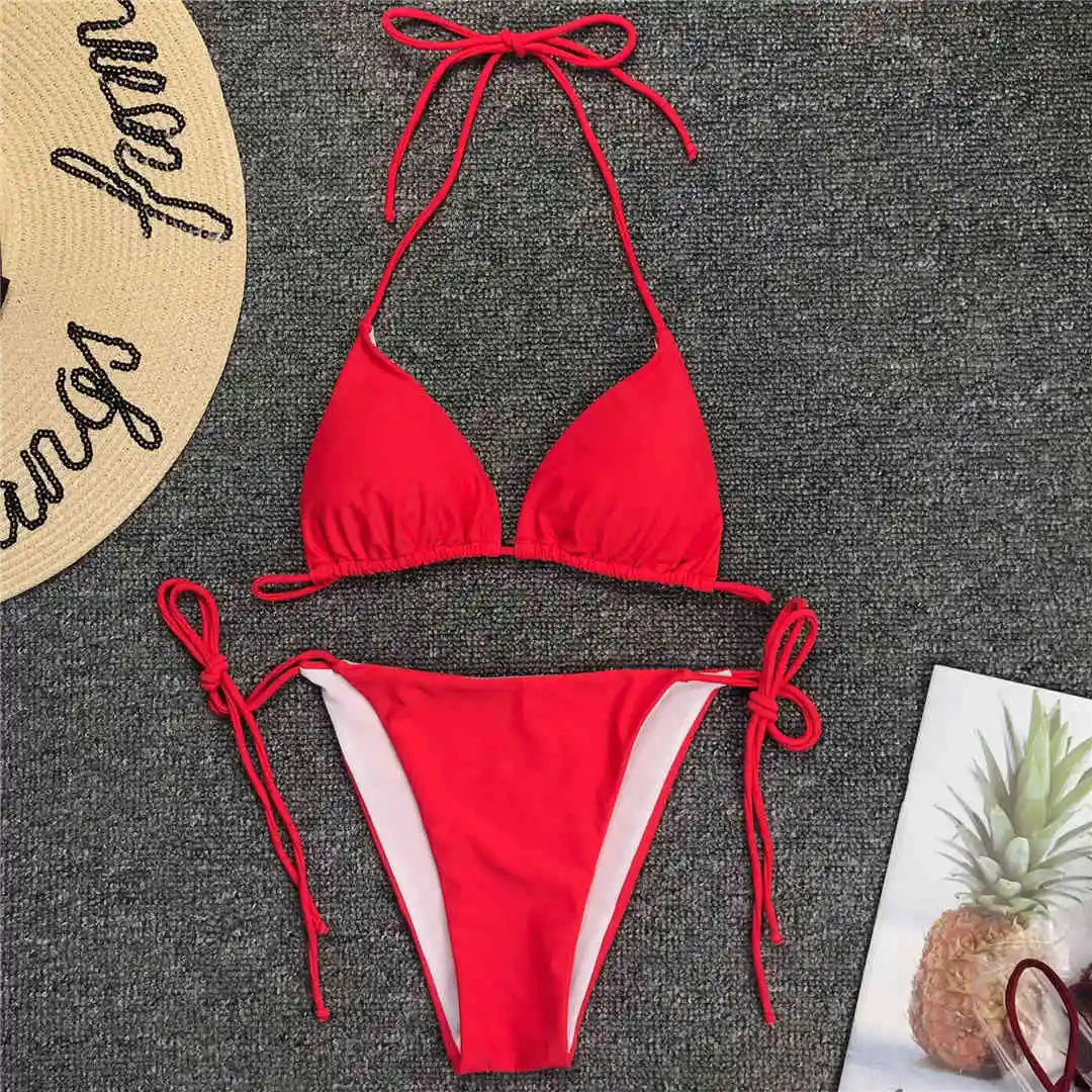 Neon pink Brazilian bikini set for women featuring halter top and matching bottoms, stylish swimwear from The Clothing Company Sydney.
