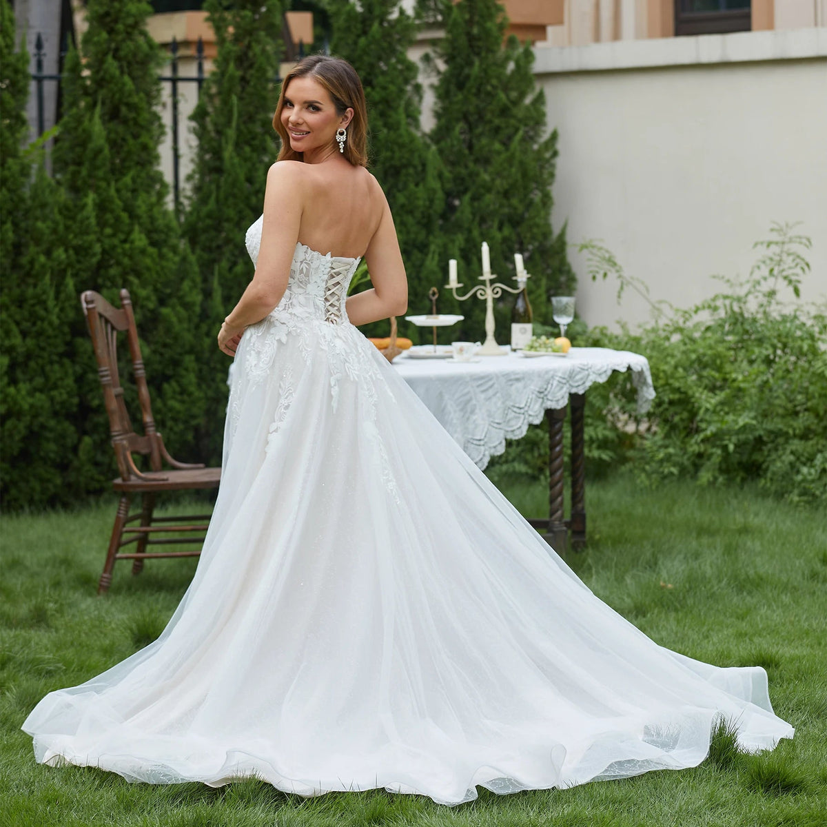 Elegant sleeveless lace wedding dress with deep V-neck and sparkly details, featuring a sweetheart neckline, by The Clothing Company Sydney.