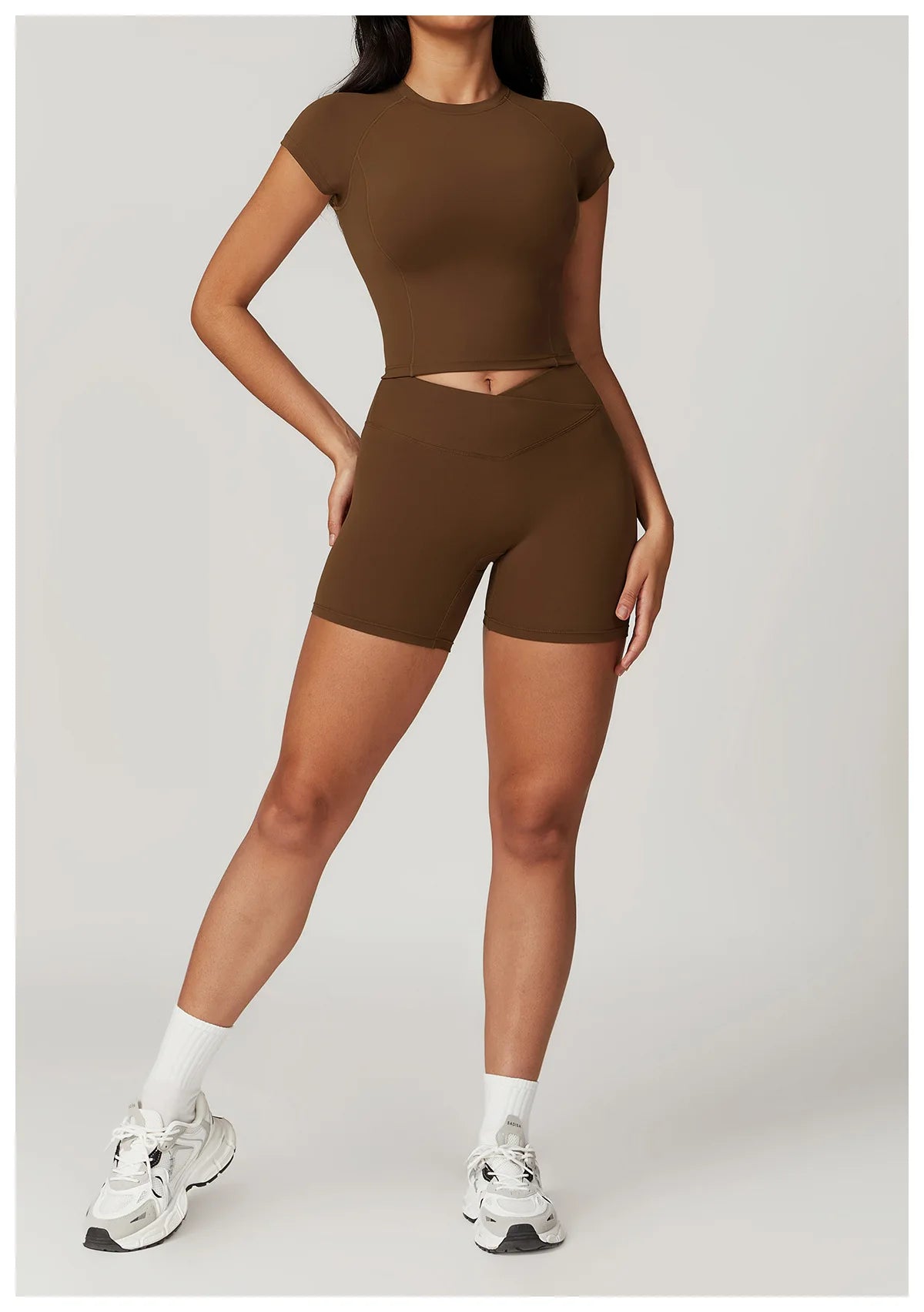 Set of women's fitness yoga gym clothes including a crop top, sports bra, leggings, and bike shorts from The Clothing Company Sydney.