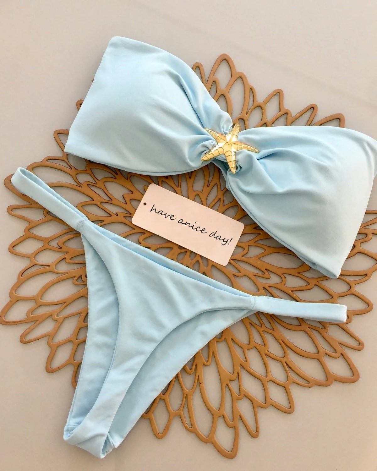 Two-piece push-up bikini swimsuit with bandeau top and Brazilian bottoms, stylish beachwear by The Clothing Company Sydney.