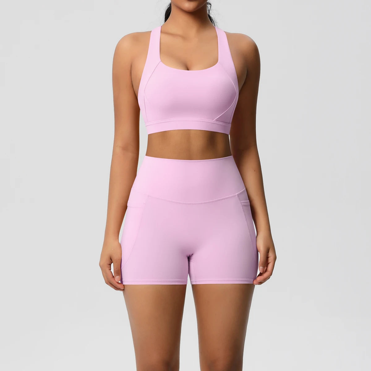 Fitness women's 2-piece sportswear set with pocketed gym clothes, crossover bra, and leggings from The Clothing Company Sydney.