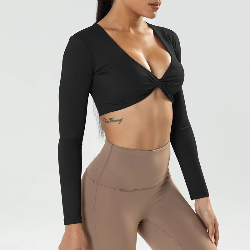 The Clothing Company Sydney long sleeve gym crop top with twist design, deep V neckline, quick-dry fabric, padded for fitness and yoga.