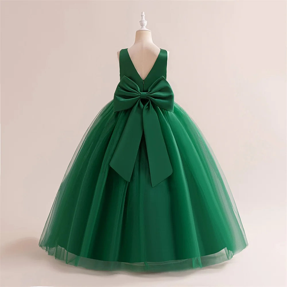 Girls long white bridesmaid and prom gown with a big bow, formal evening dress for kids by The Clothing Company Sydney.
