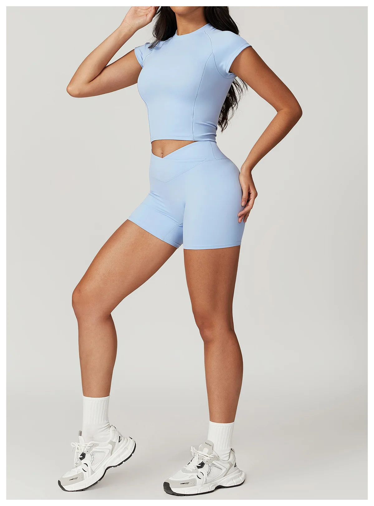 Two-piece women's fitness set with short sleeve crop top and leggings, from The Clothing Company Sydney, suitable for yoga and gym workouts.