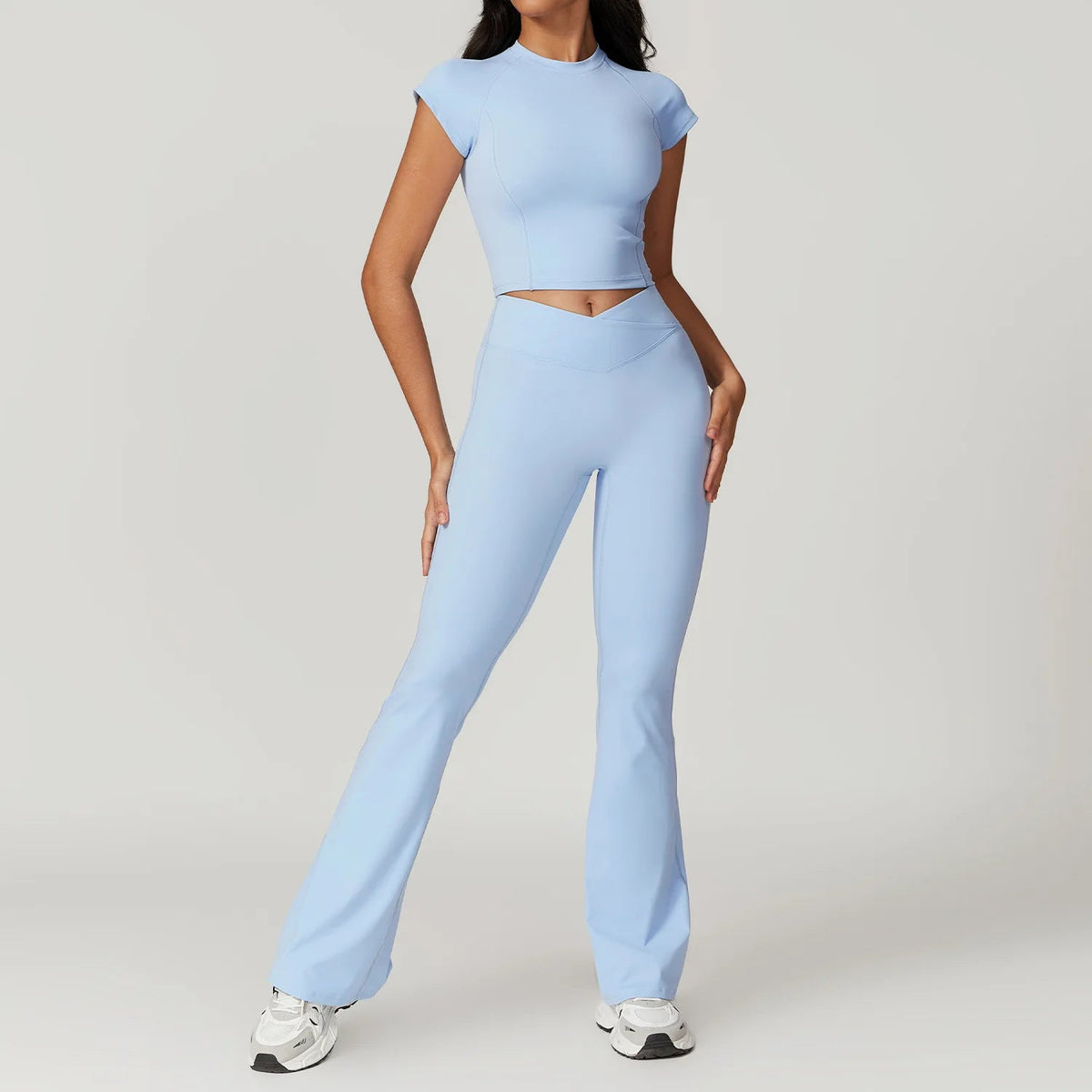 Two-piece women's fitness sportswear set including a short sleeve crop top, sports bra, and leggings from The Clothing Company Sydney.