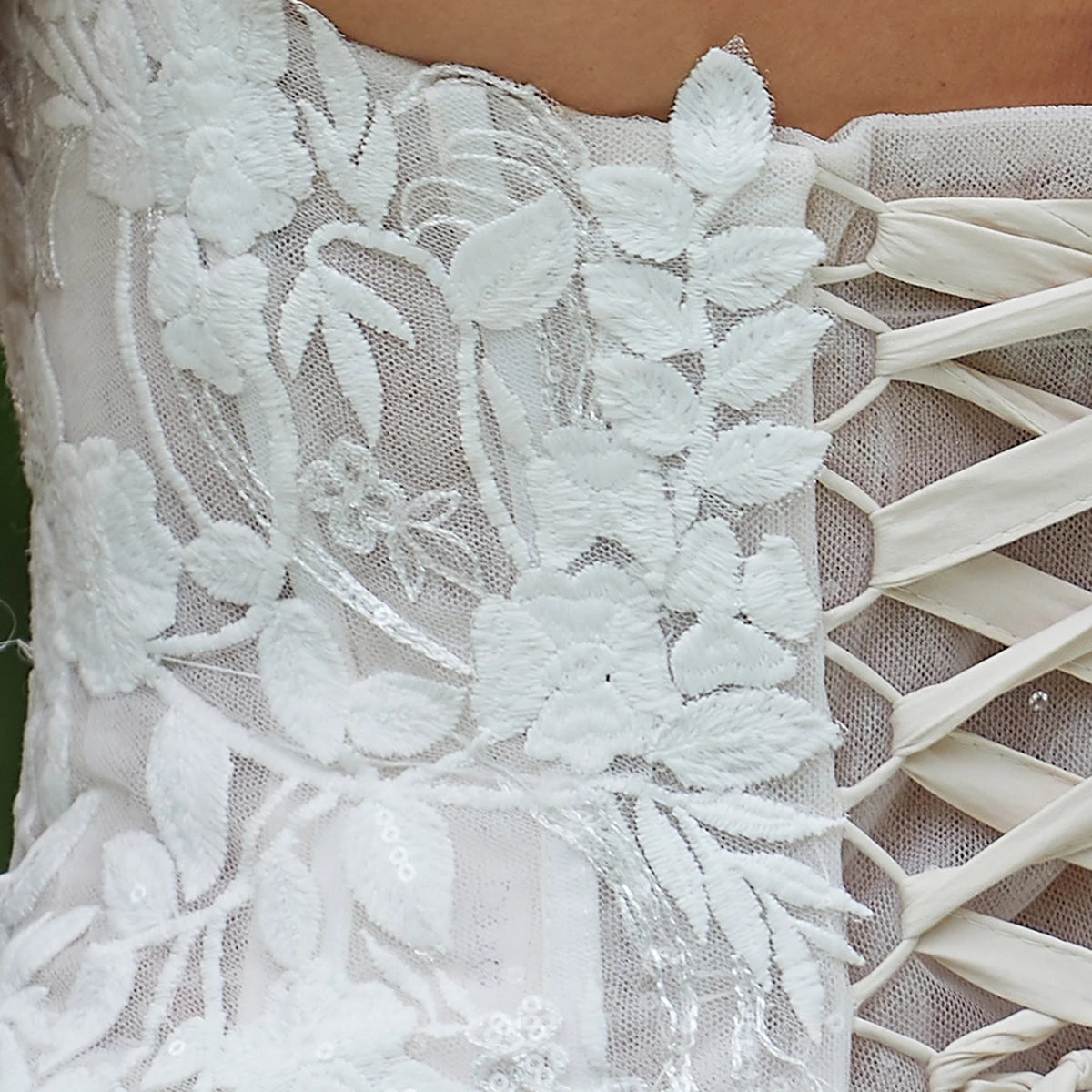 Elegant sleeveless lace wedding dress with deep V-neck and sparkle details, designed by The Clothing Company Sydney.