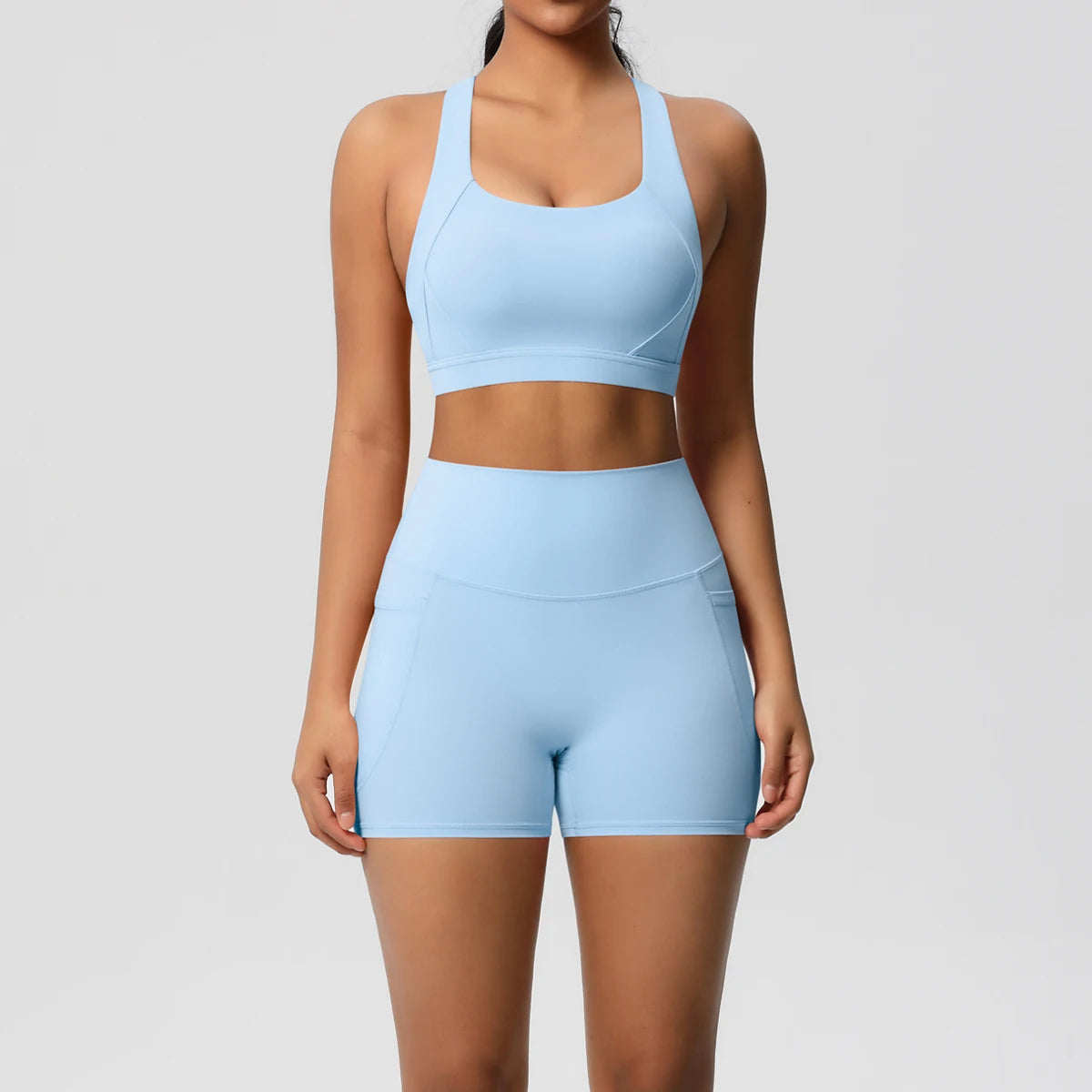 Women’s fitness sportswear set with crossover bra, leggings, gym shorts, and pocketed track jacket from The Clothing Company Sydney.