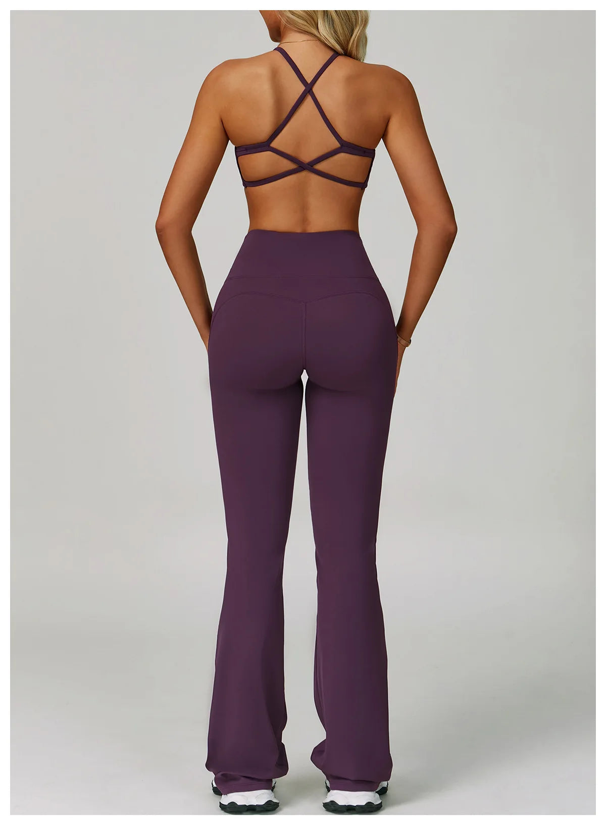 Two-piece women's fitness tracksuit with high-waist leggings and sports bra, perfect for yoga, workout, or gym activities.