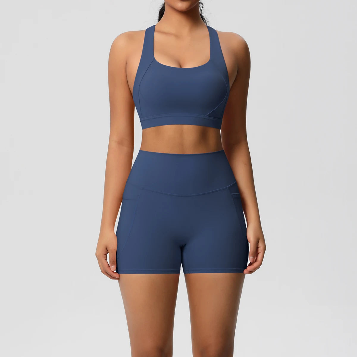 Women’s 2-piece sportswear set with pocketed gym shorts, crossover bra, and leggings from The Clothing Company Sydney.