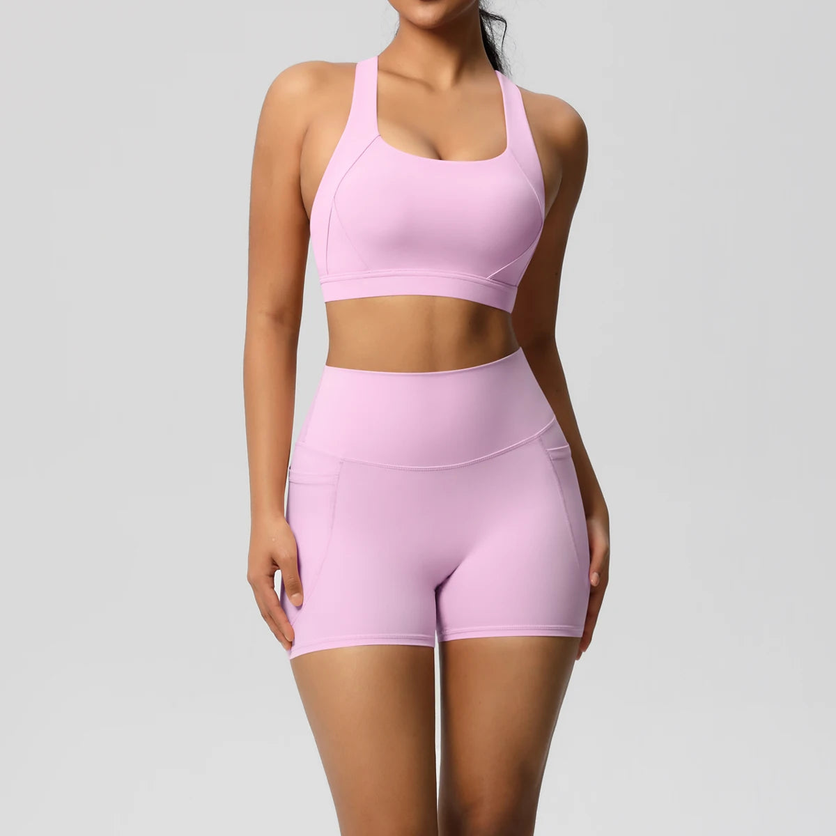 Two-piece women's sportswear yoga set with crossover bra, bike shorts, and leggings from The Clothing Company Sydney.