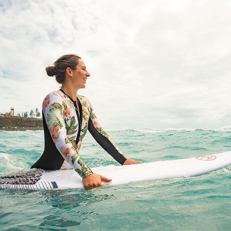 Black one-piece rashguard swimsuit by The Clothing Company Sydney, featuring long sleeves and a sleek beach-ready design.