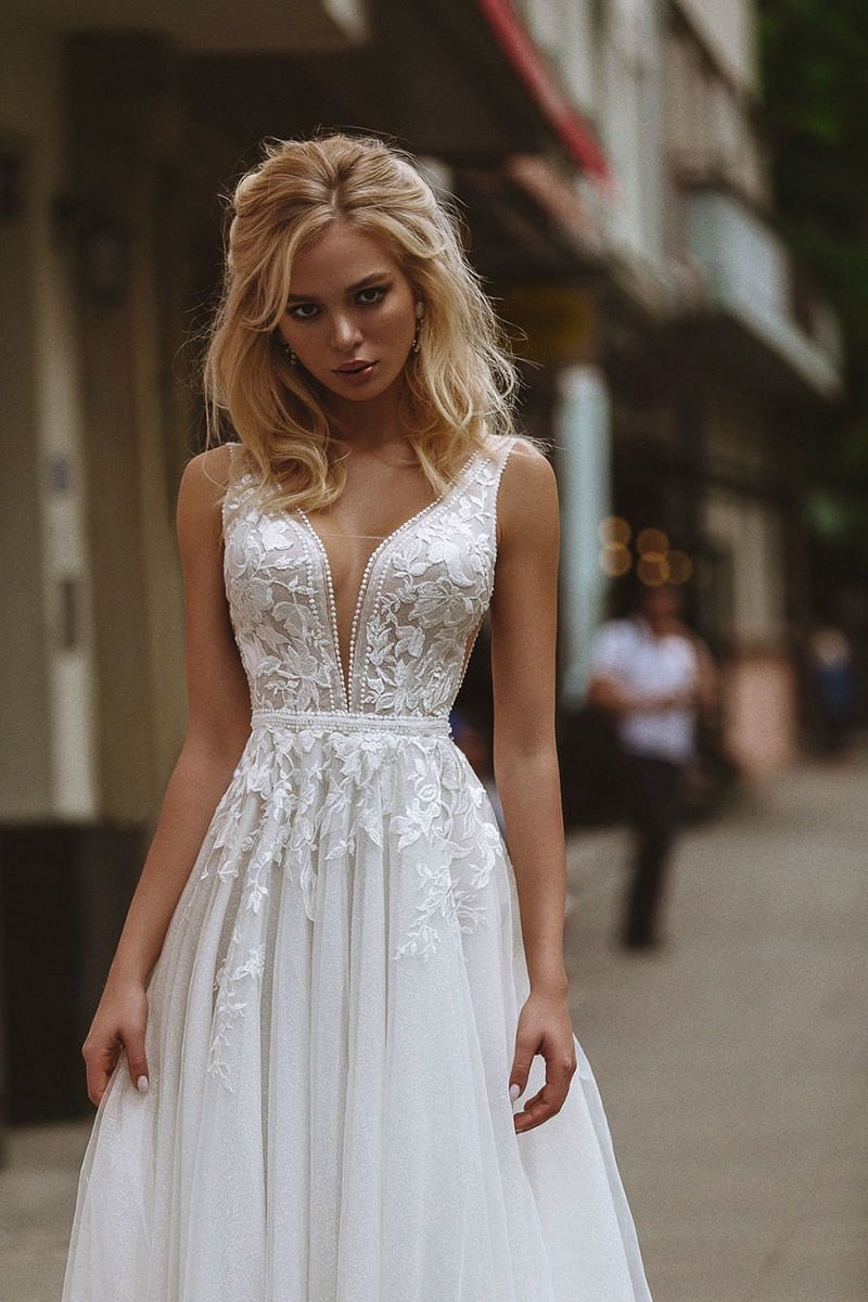 Boho wedding dress with deep V-neck, lace appliques, pearl buttons, A-line tulle skirt, beach bridal gown by The Clothing Company Sydney