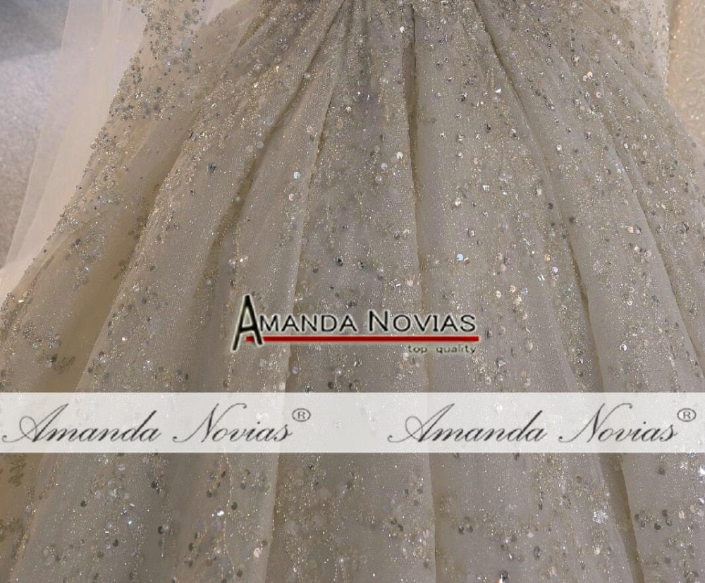 Luxury wedding dress with heavy beading, elegant bridal gown by The Clothing Company Sydney, featuring intricate beadwork and a flowing silhouette.
