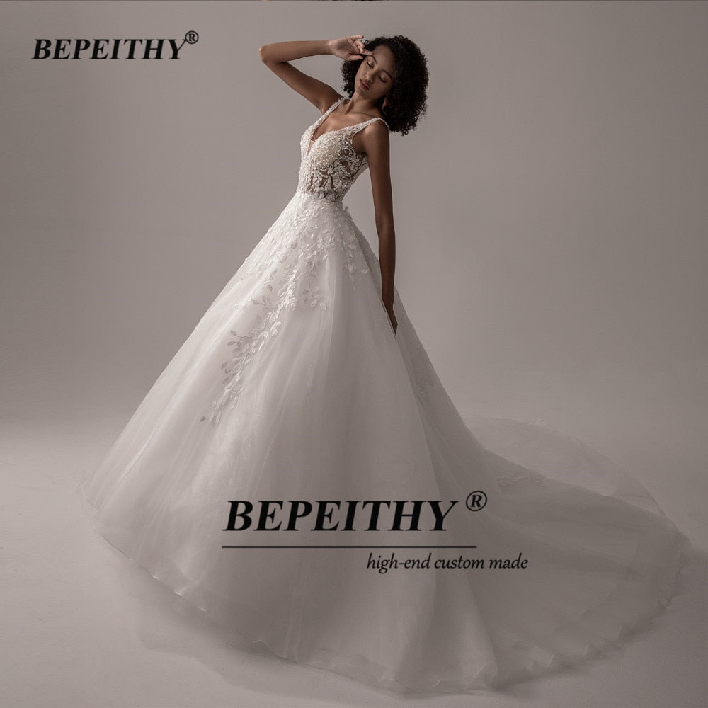 Ivory V-neck sleeveless wedding dress with lace details, A-line silhouette, romantic boho bridal gown by The Clothing Company Sydney