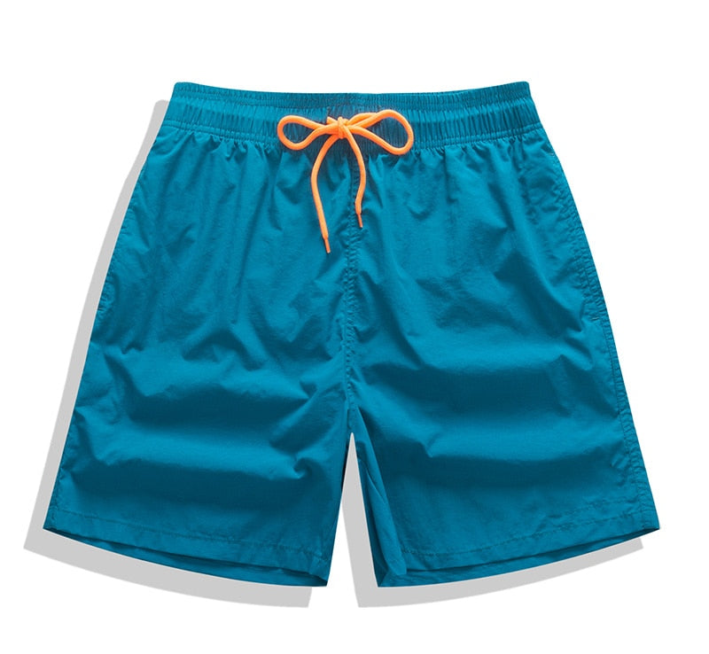 Men's swim shorts by The Clothing Company Sydney featuring blue and white surf-style board shorts with adjustable waistband.