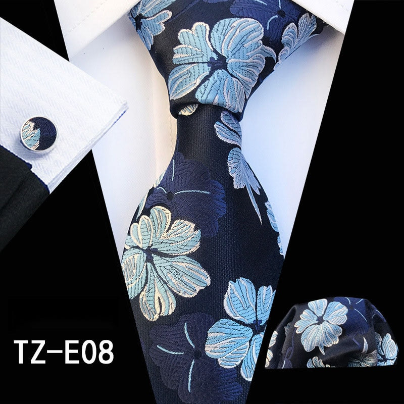 Red and green floral silk tie set with matching handkerchief and cufflinks, stylish accessories for men's business and wedding attire.