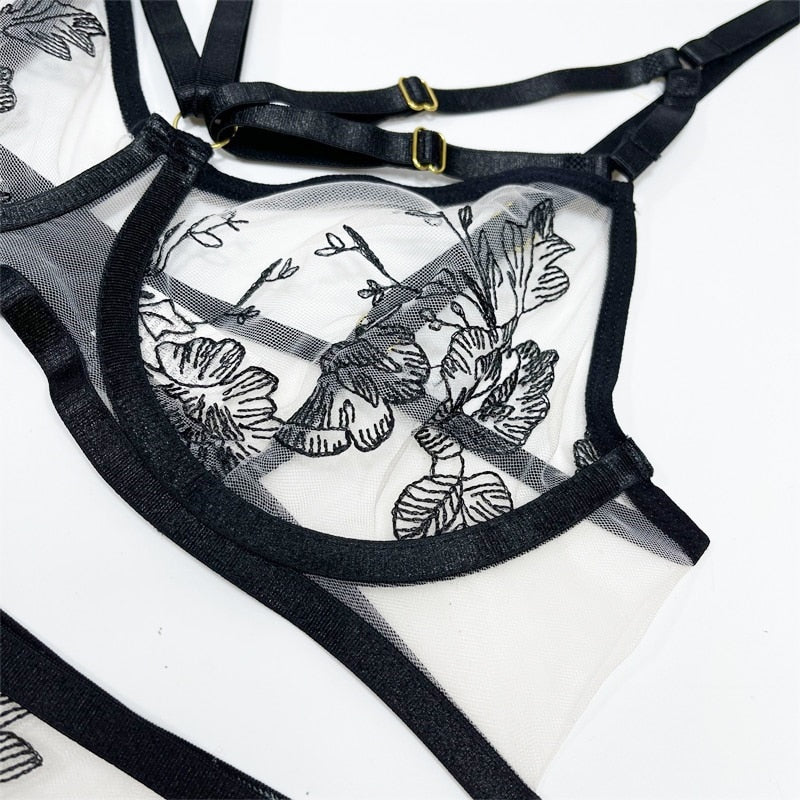 Elegant 3-piece lingerie set by The Clothing Company Sydney featuring sensual embroidery, transparent briefs, lace, and matching garters.