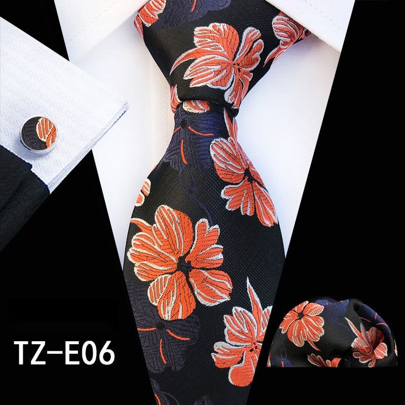 Red and green floral silk tie set for men with matching handkerchief, cufflinks, and necktie, stylish accessories for business or wedding.