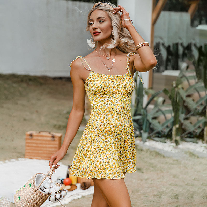 Yellow floral print women's romper from The Clothing Company Sydney with spaghetti straps, sleeveless design, perfect for summer holidays.