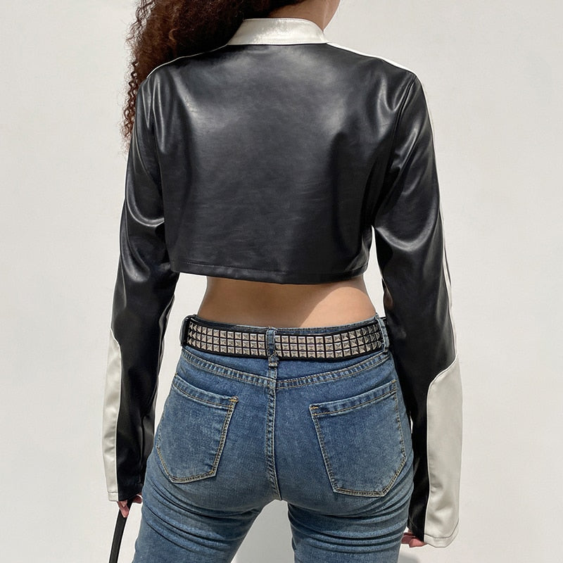 Punk style patchwork cropped PU leather jacket for women with zippers, contrast color details, ideal for autumn and winter fashion.