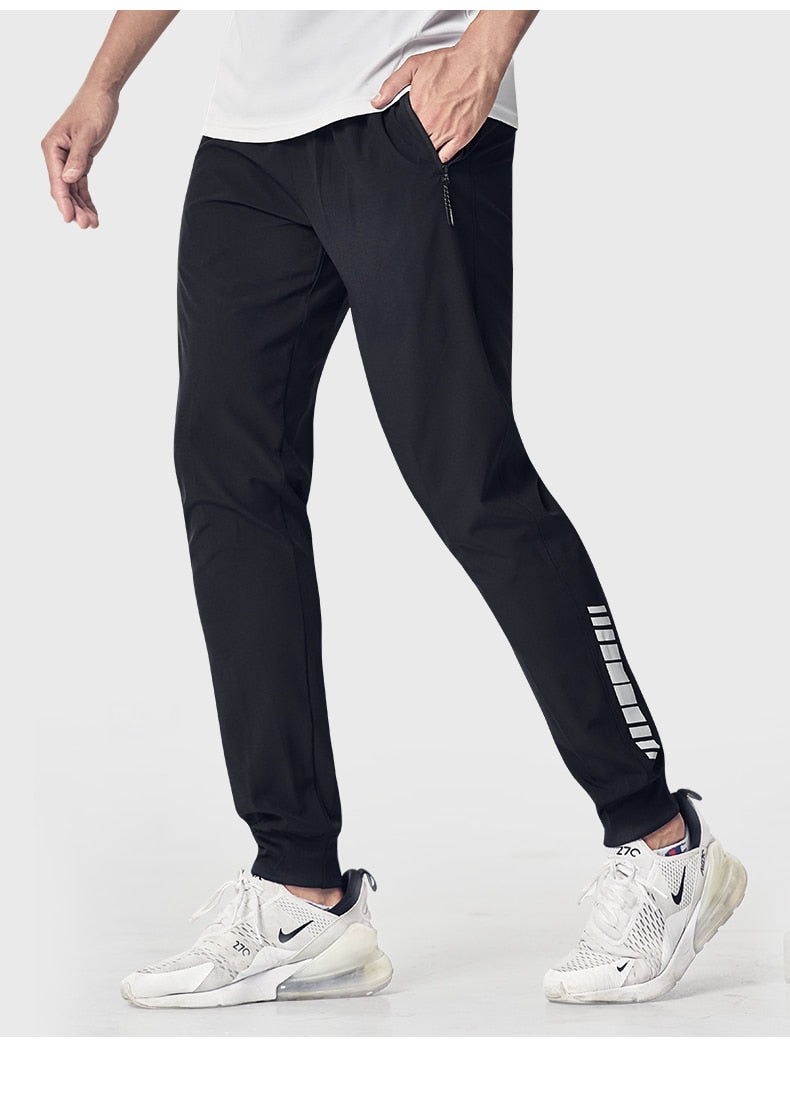 Men's quick-drying sports running pants with zipper pockets, ideal for training, jogging, soccer, and fitness activities.