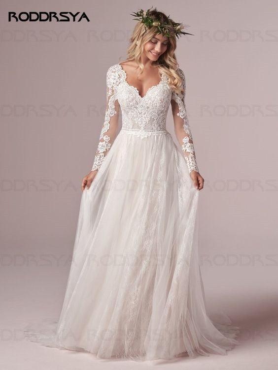 Ivory A-line long sleeve wedding dress with lace details, tulle fabric, and an open back design by The Clothing Company Sydney.