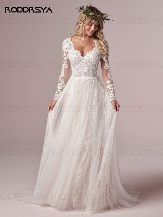Ivory A-line long sleeve wedding dress with lace and tulle, open back design, by The Clothing Company Sydney.