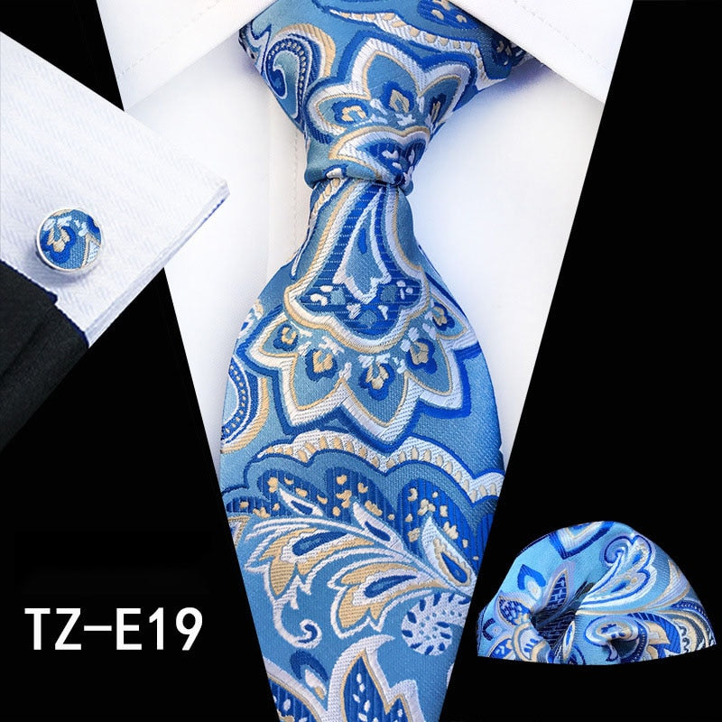 Red and green floral silk tie set with matching handkerchief, cufflinks, and necktie for men's accessories, suitable for business and wedding.