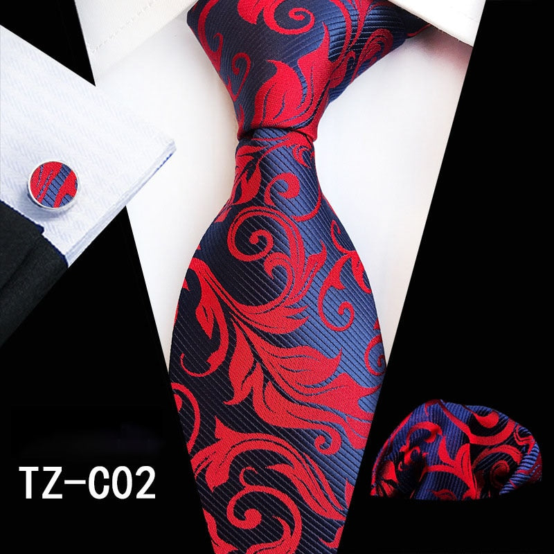 Red and green floral silk tie set with matching handkerchief and cufflinks, stylish accessories for men’s business and wedding attire.