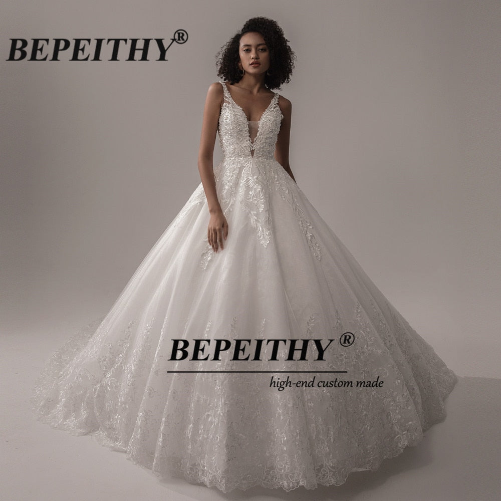 Ivory V-neck sleeveless wedding dress with lace details, A-line silhouette, romantic boho bridal gown by The Clothing Company Sydney