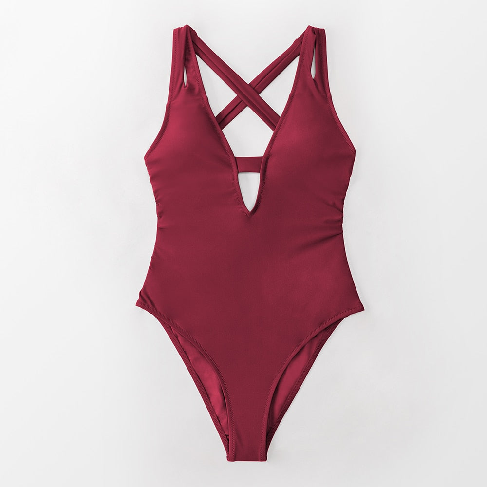 Solid dark blue one-piece swimsuit by The Clothing Company Sydney featuring a deep V-neck, backless design, and X-back style.