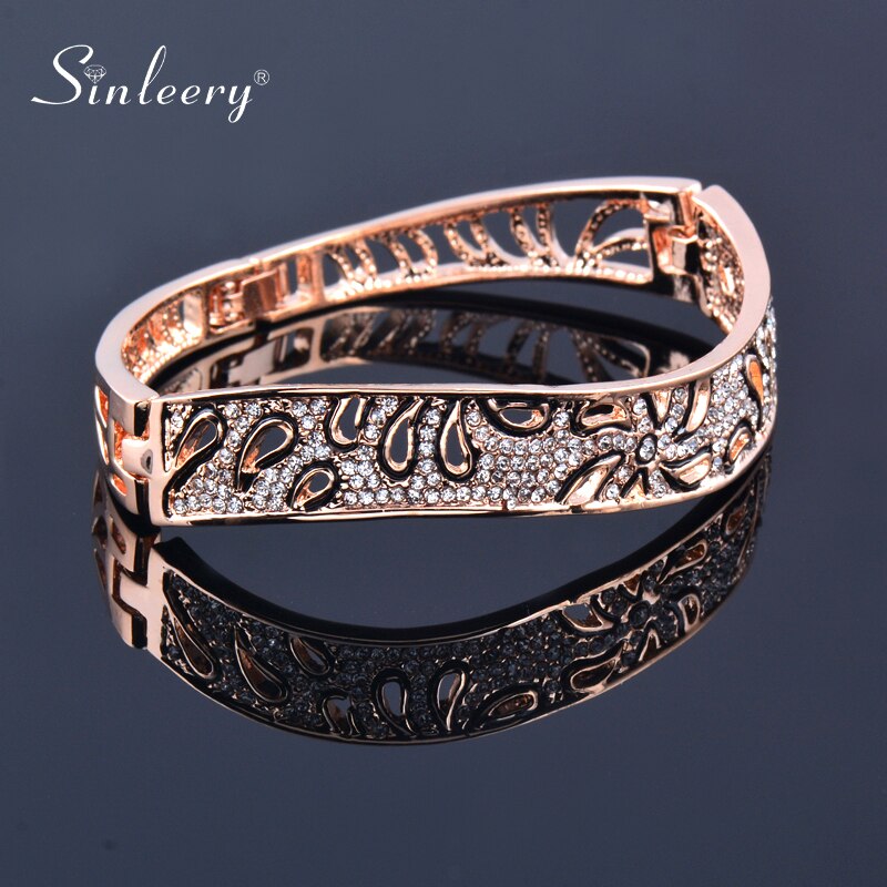 Rose gold and silver flower-shaped crystal bangles for women, featuring intricate hollow designs and elegant jewelry style.
