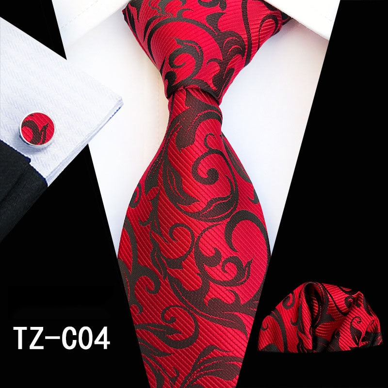Men's silk tie set with red and green floral pattern, includes cufflinks, handkerchief, and necktie from The Clothing Company Sydney.