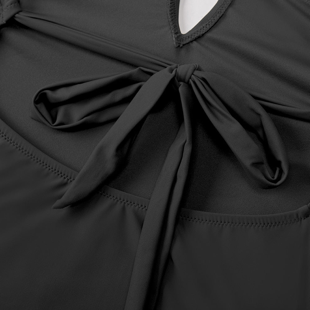 Dark blue one-piece swimsuit with deep V-neck and open back, featuring X-back design, from The Clothing Company Sydney.