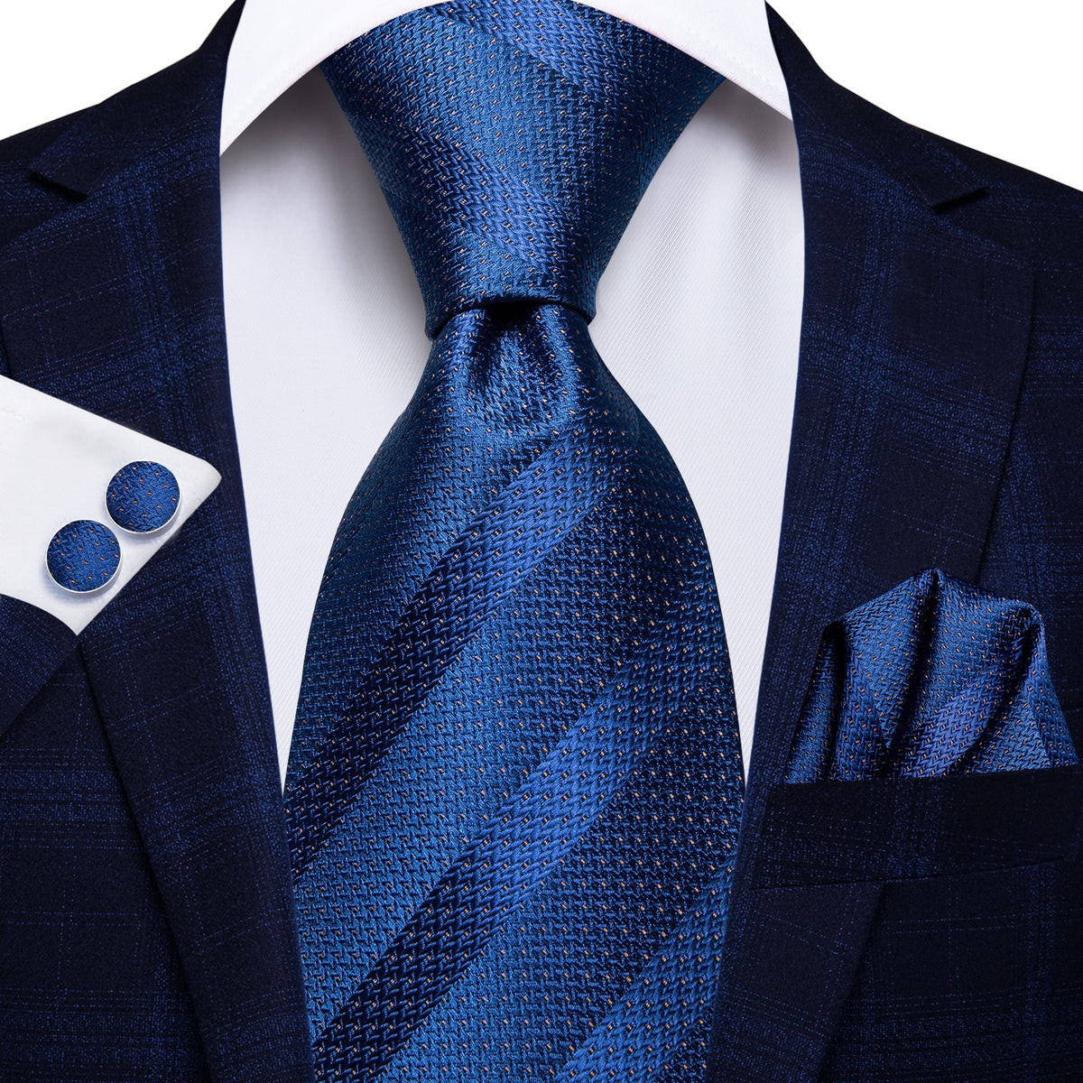 Three men's silk accessories including paisley tie, pocket square, and cufflinks, in elegant formal style.