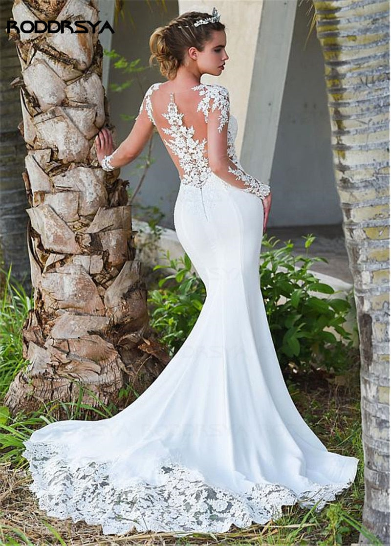 Long sleeve sheer lace appliqué mermaid wedding dress with see-through back and button details, elegant bridal gown by The Clothing Company Sydney