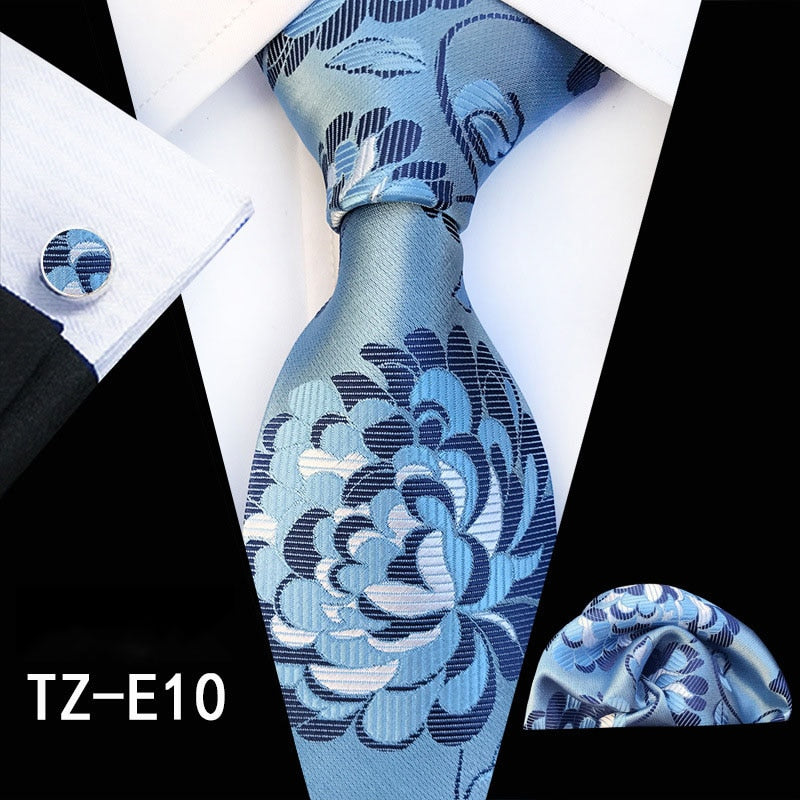 Red and green floral silk necktie set with matching handkerchief, cufflinks, and suit accessories for men's business and wedding attire.