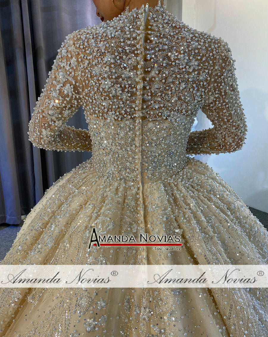 Luxury full pearls wedding dress with long train from The Clothing Company Sydney, featuring intricate pearl embellishments and elegant design.