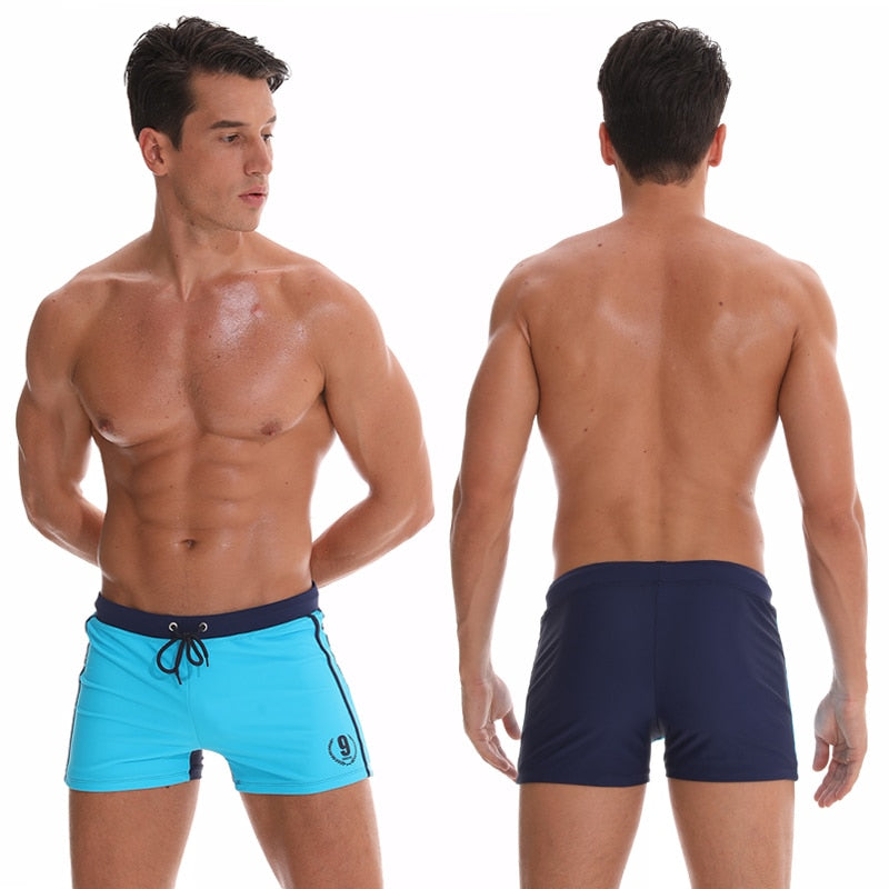 Men's breathable swim trunks from The Clothing Company Sydney, featuring classic boxer brief style and beach shorts design.