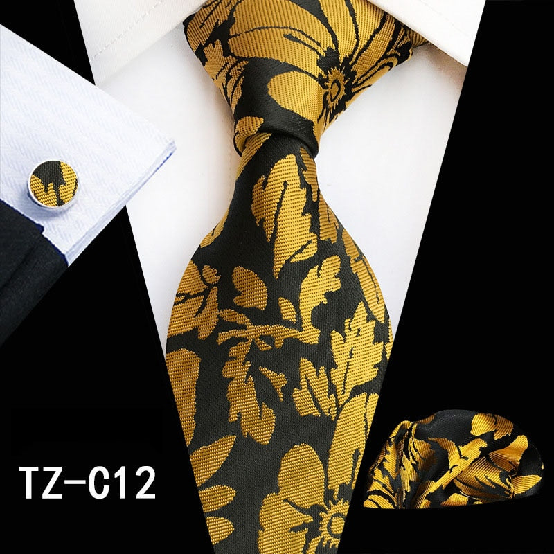 Red and green floral silk tie set with matching handkerchief and cufflinks, featuring a stylish men's accessories ensemble.