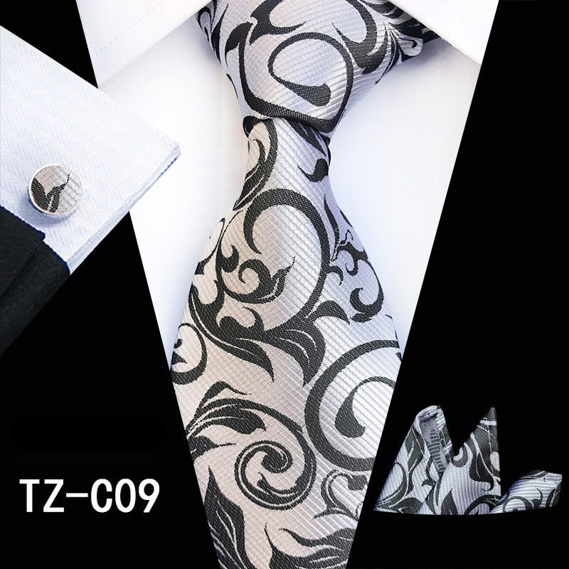 Red and green floral silk tie set with matching handkerchief and cufflinks, stylish men's accessories for business or weddings.