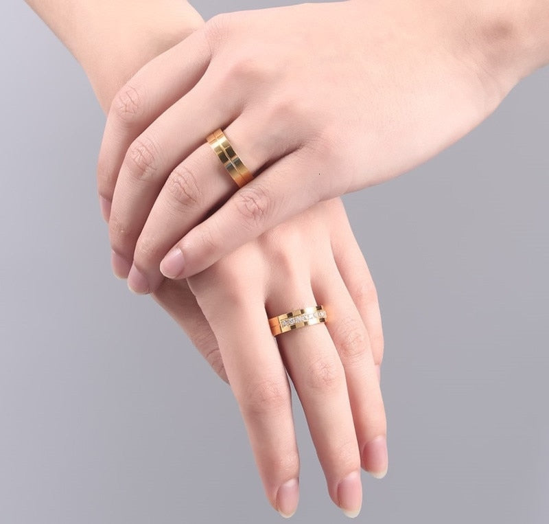 Gold-tone stainless steel wedding band bracelet for women and men with CZ stones, symbolizing love and commitment.