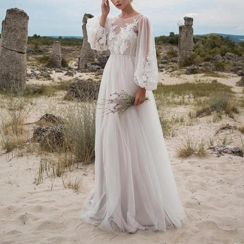 White long-sleeve tulle wedding dress with embroidery and lace details, perfect as a maxi tunic or beach vacation gown.