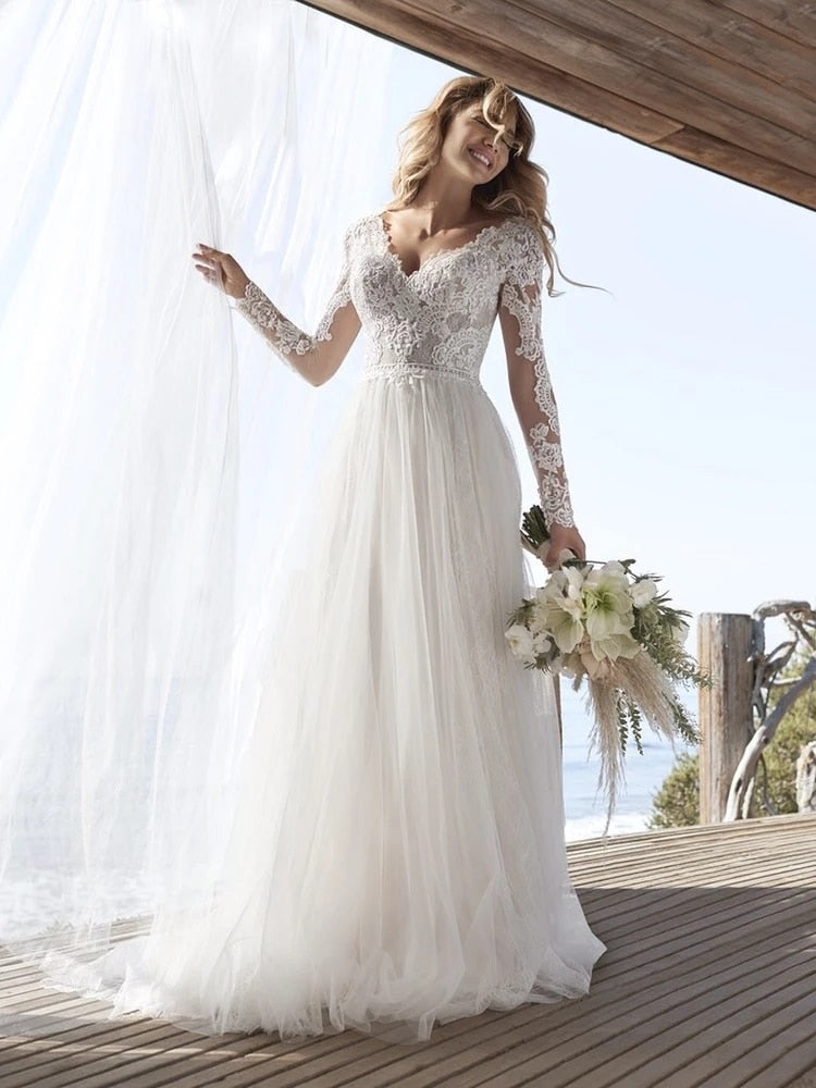 Ivory A-line long sleeve wedding dress with lace and tulle, open back design, by The Clothing Company Sydney