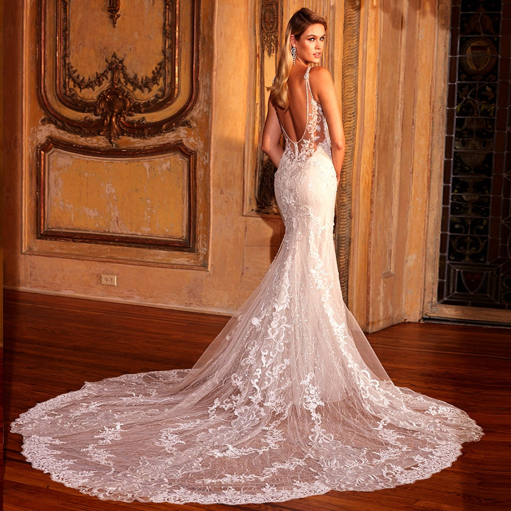 Elegant shiny mermaid wedding gown by The Clothing Company Sydney, featuring V-neck, backless design, lace appliques, and beading details.