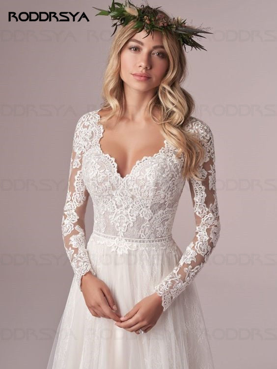 Ivory A-line long sleeve wedding dress with lace details, tulle fabric, open back, designed by The Clothing Company Sydney