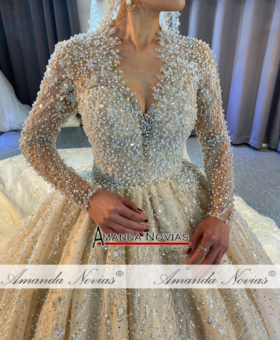 Luxury full pearls wedding dress with long train by The Clothing Company Sydney, featuring intricate pearl detailing and elegant train.