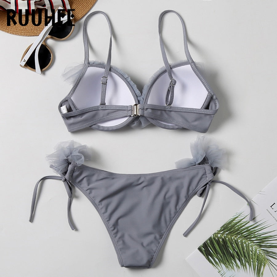 Two-piece leopard print bandeau bikini set for women, featuring ruffle design and push-up fit, ideal for beach and swimwear fashion.